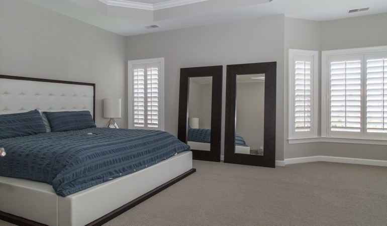 Polywood shutters in a minimalist bedroom in Dallas.